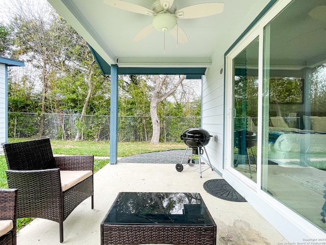 view of patio with area for grilling and ceiling fan