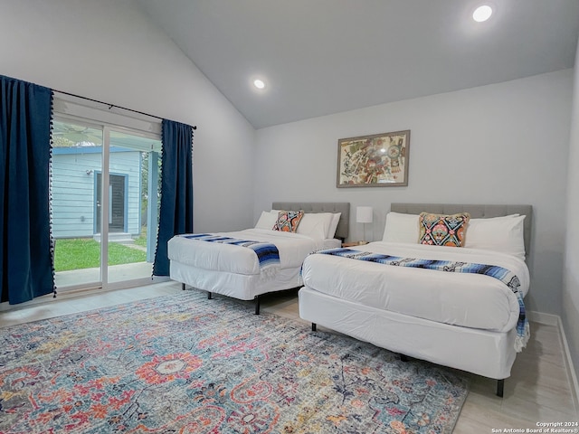 bedroom with access to exterior and high vaulted ceiling