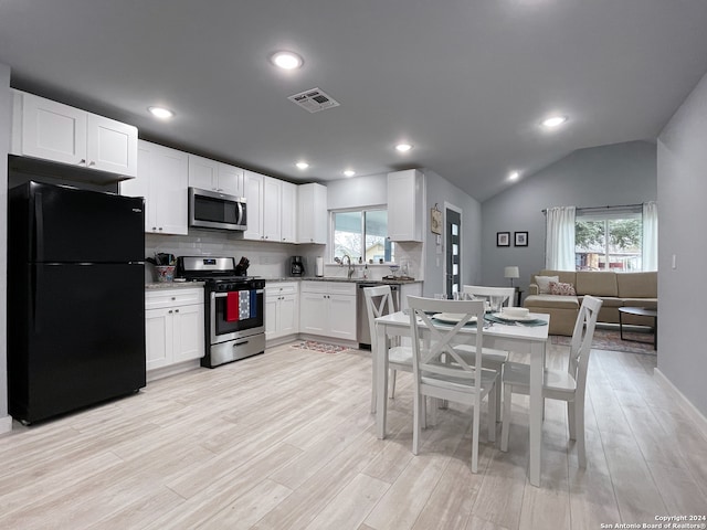 kitchen featuring light hardwood / wood-style floors, appliances with stainless steel finishes, a wealth of natural light, and white cabinets