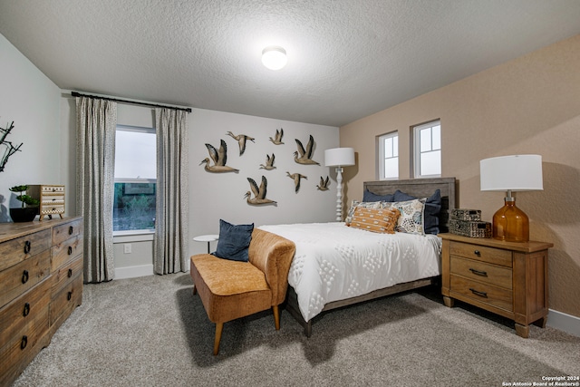 carpeted bedroom featuring a textured ceiling