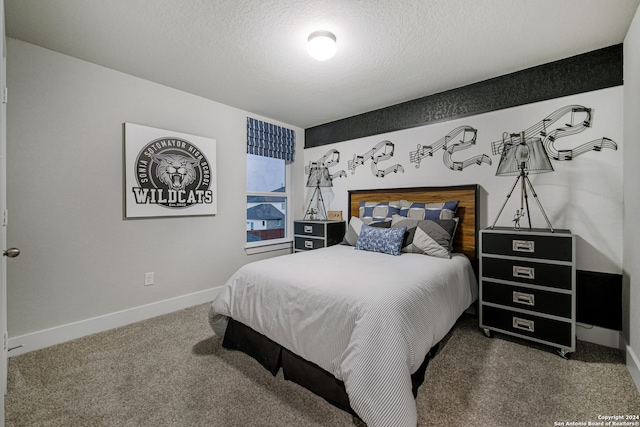 carpeted bedroom featuring a textured ceiling