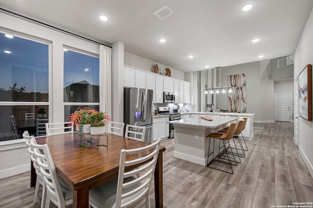 dining room with light wood-type flooring