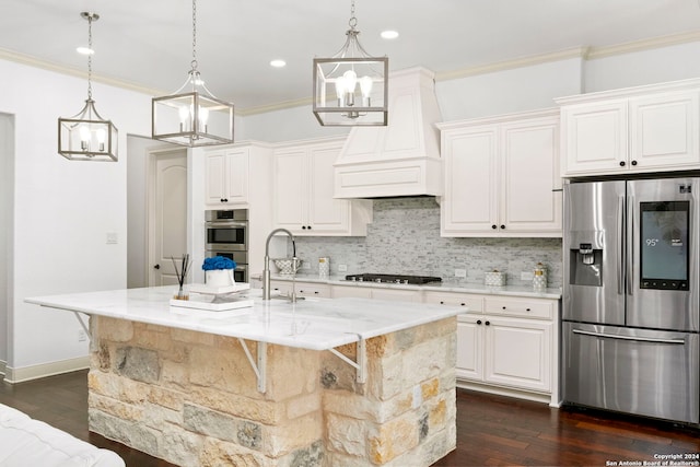 kitchen featuring a breakfast bar, premium range hood, white cabinetry, appliances with stainless steel finishes, and an island with sink