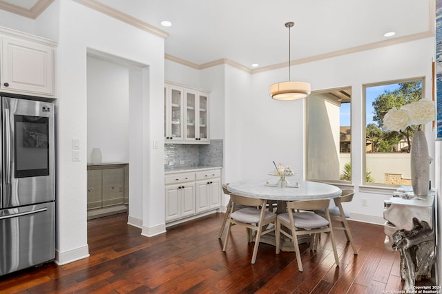 dining room featuring dark wood-type flooring and ornamental molding