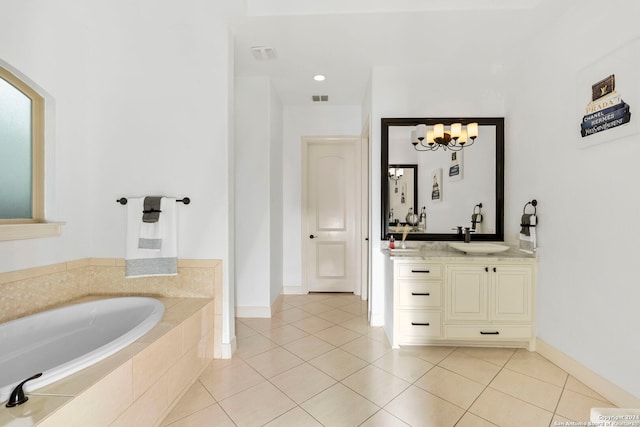 bathroom featuring a notable chandelier, vanity, a relaxing tiled tub, and tile patterned floors