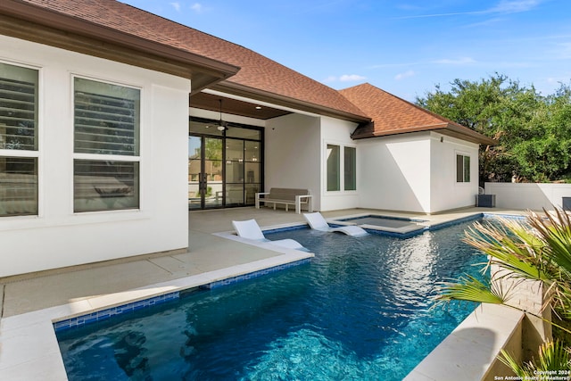 view of pool featuring an in ground hot tub, central AC unit, ceiling fan, and a patio area