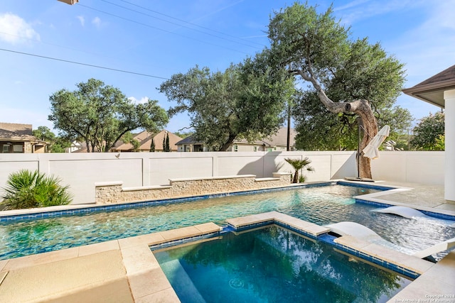 view of pool with an in ground hot tub