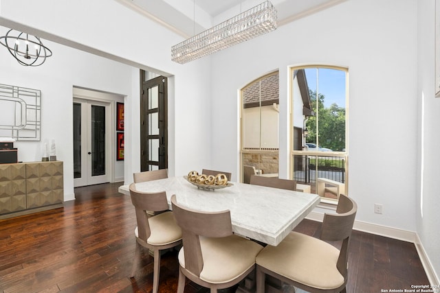 dining space featuring dark hardwood / wood-style floors, a notable chandelier, and french doors