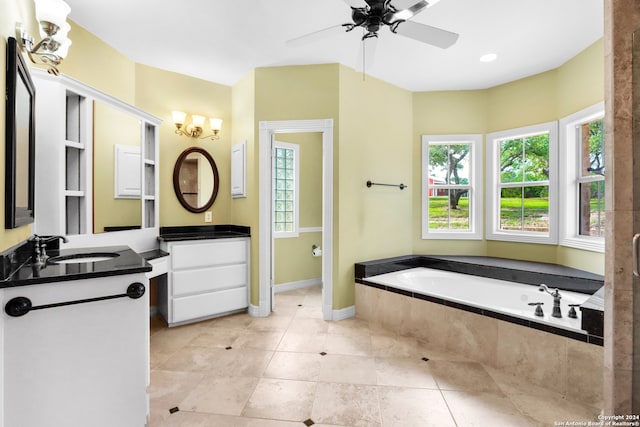 bathroom with a relaxing tiled tub, ceiling fan with notable chandelier, tile patterned floors, and double sink vanity