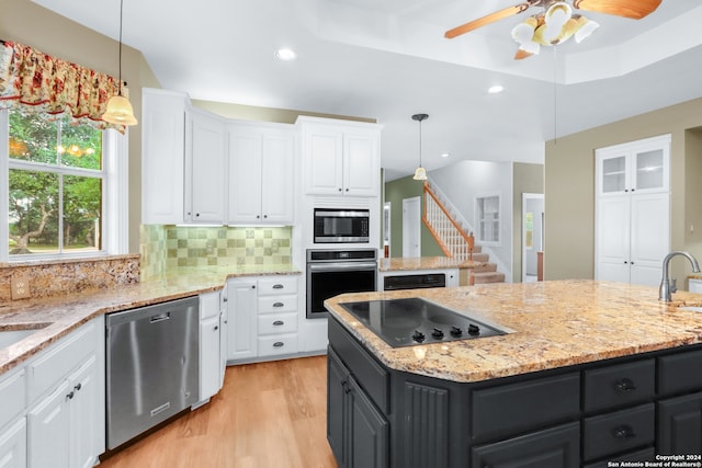 kitchen featuring appliances with stainless steel finishes, ceiling fan, and white cabinets