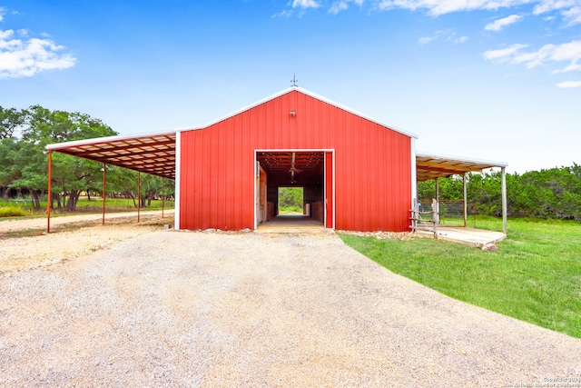 view of outbuilding featuring a yard and a carport