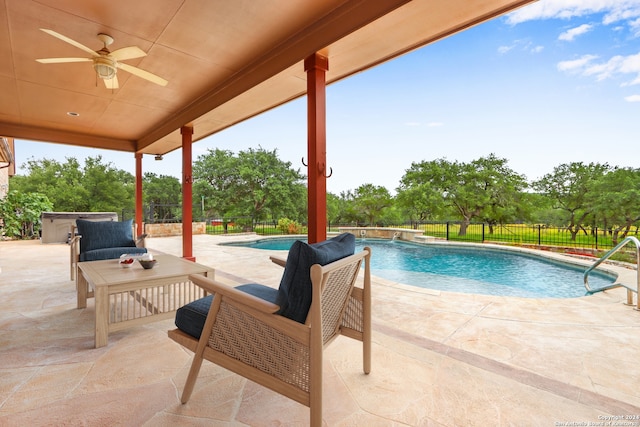 view of pool with a patio area and ceiling fan