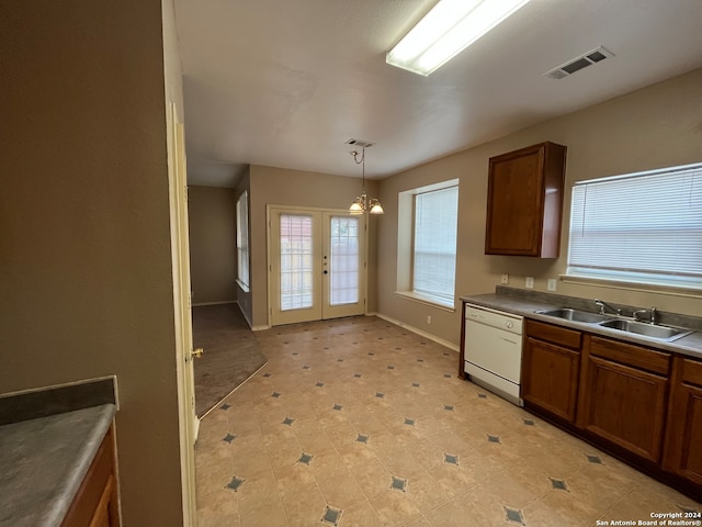 kitchen featuring sink, hanging light fixtures, white dishwasher, and light tile patterned floors