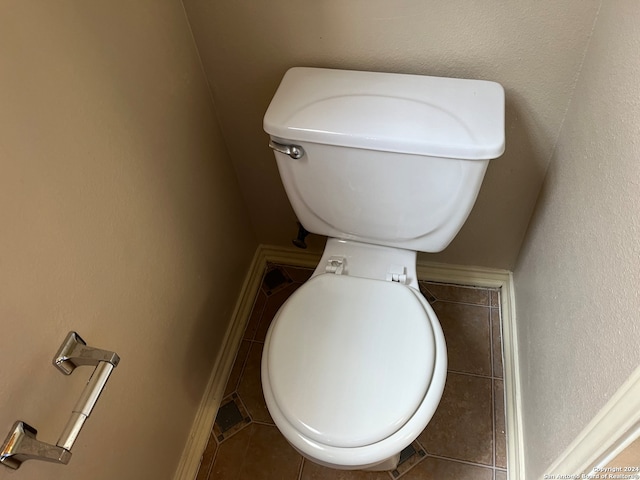 bathroom with toilet and tile patterned flooring