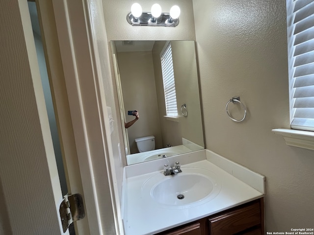 bathroom with vanity and toilet