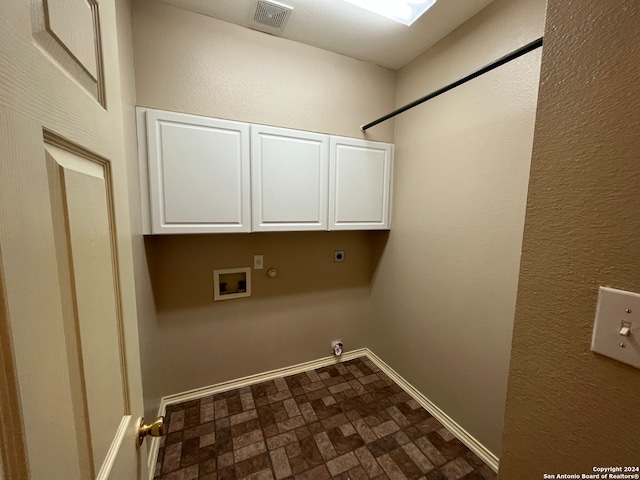 clothes washing area with hookup for a washing machine, hookup for a gas dryer, cabinets, dark tile patterned flooring, and hookup for an electric dryer