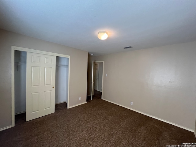 unfurnished bedroom with a closet and carpet floors