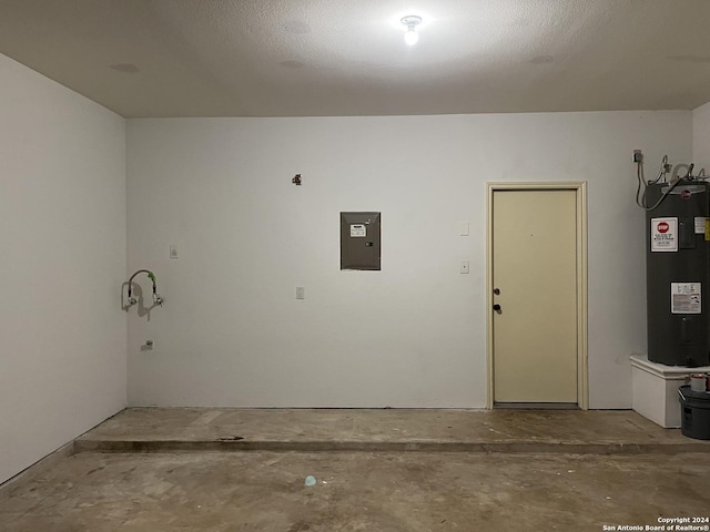 garage featuring electric water heater and electric panel