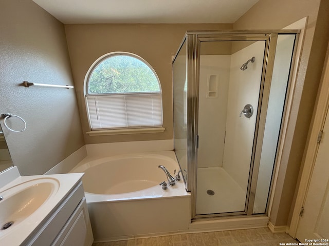 bathroom featuring independent shower and bath, tile patterned floors, and vanity