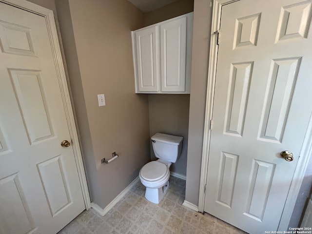 bathroom featuring tile patterned flooring and toilet