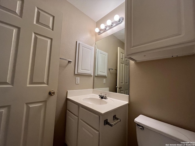 bathroom featuring toilet and vanity