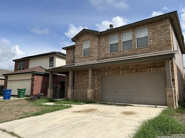 view of front facade with a garage, concrete driveway, and brick siding