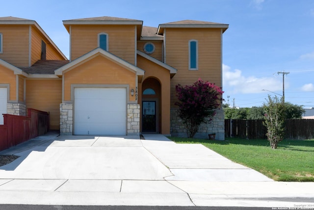 view of front of house featuring a garage and a front lawn