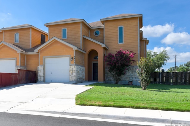 view of front of property with a garage and a front lawn