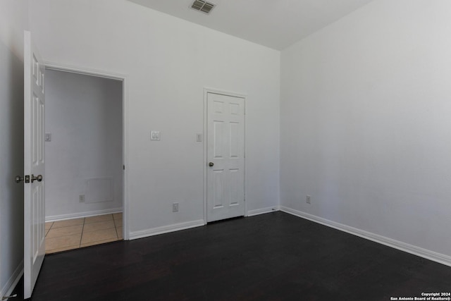 spare room with dark hardwood / wood-style flooring