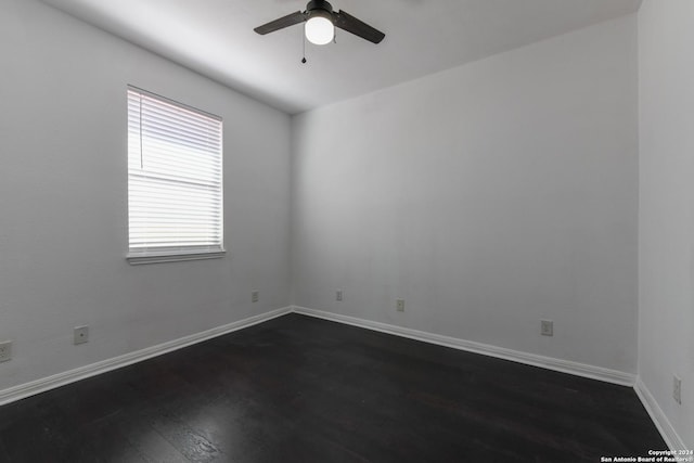 spare room featuring ceiling fan and dark hardwood / wood-style floors