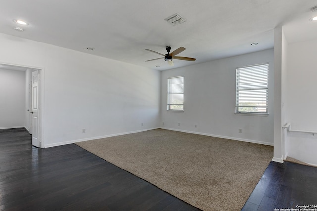 spare room with ceiling fan and dark hardwood / wood-style flooring