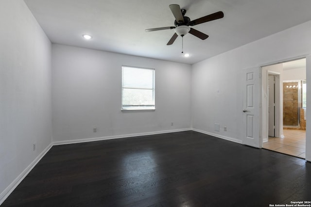 empty room featuring ceiling fan and dark hardwood / wood-style flooring