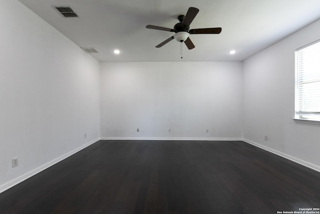 empty room with dark wood-type flooring and ceiling fan