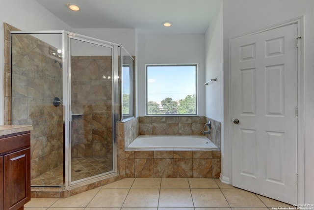 bathroom featuring tile patterned flooring, vanity, and separate shower and tub