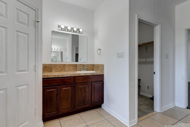 bathroom featuring tile patterned flooring and vanity