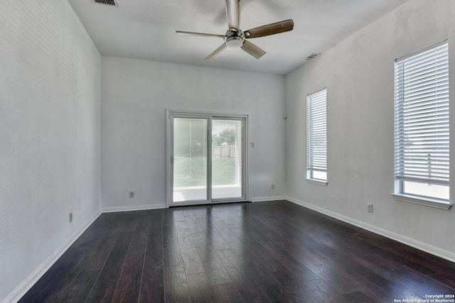 empty room with dark wood-type flooring and ceiling fan