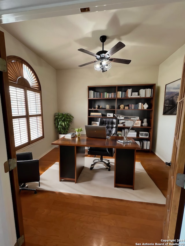 office area with ceiling fan and wood finished floors