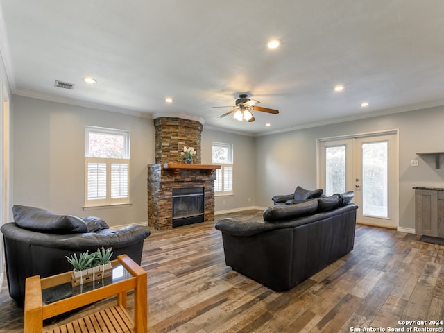 living room with a fireplace, hardwood / wood-style floors, french doors, and ornamental molding