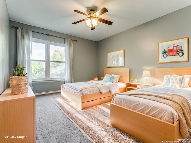 bedroom featuring carpet, baseboards, and a ceiling fan