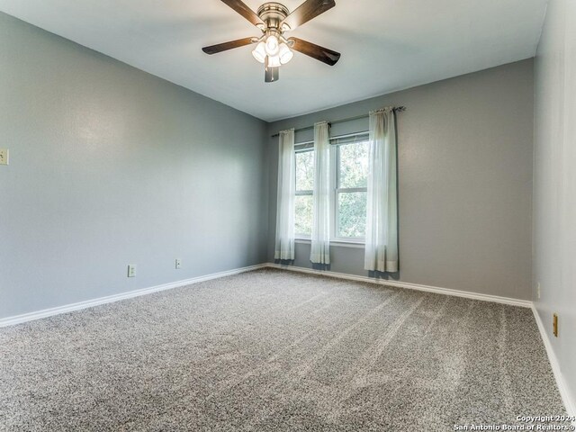 empty room featuring light wood-type flooring, baseboards, and a ceiling fan