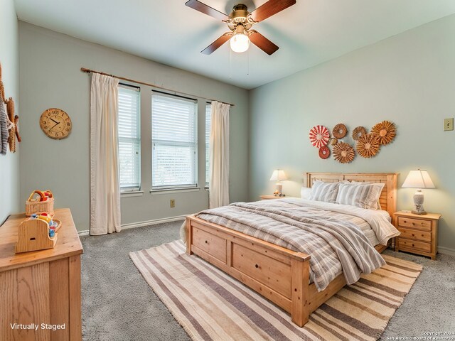 bedroom with ceiling fan, dark wood finished floors, and baseboards