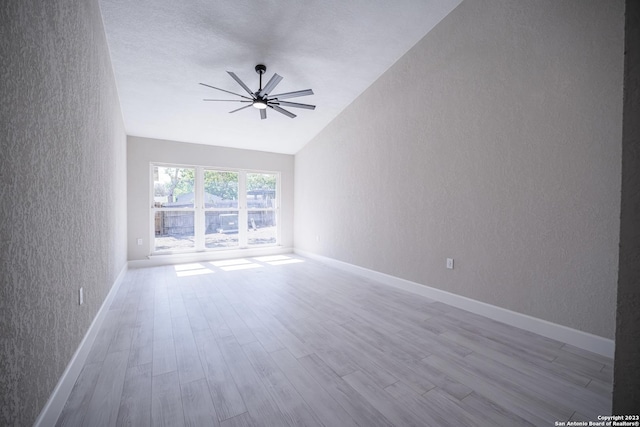 unfurnished room with ceiling fan, lofted ceiling, and light hardwood / wood-style floors