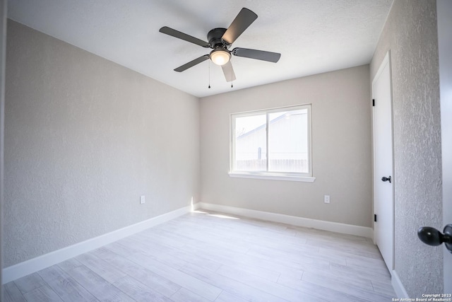 spare room featuring ceiling fan and light wood-type flooring