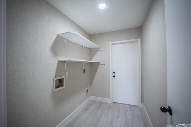 clothes washing area featuring washer hookup, hookup for an electric dryer, and light wood-type flooring