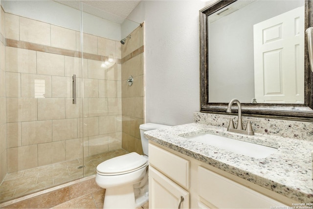 bathroom with vanity, a textured ceiling, toilet, and walk in shower