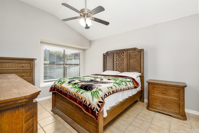 tiled bedroom with ceiling fan and vaulted ceiling