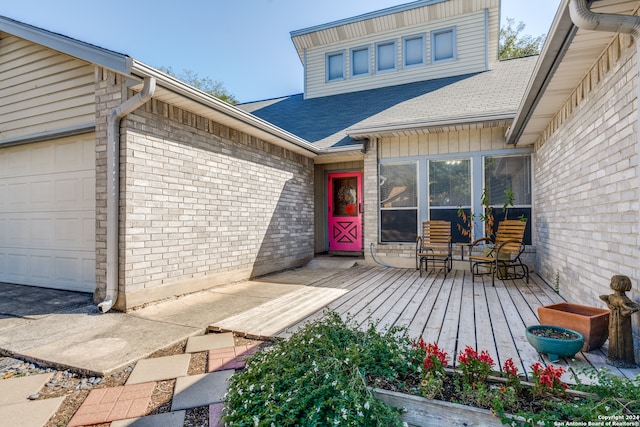 view of exterior entry featuring a deck