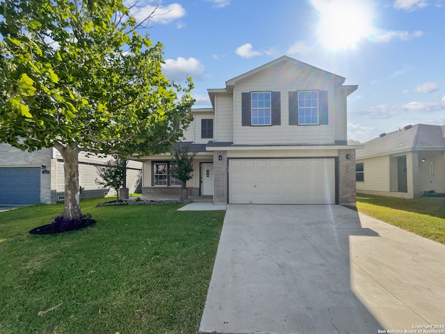 view of property featuring a garage and a front yard