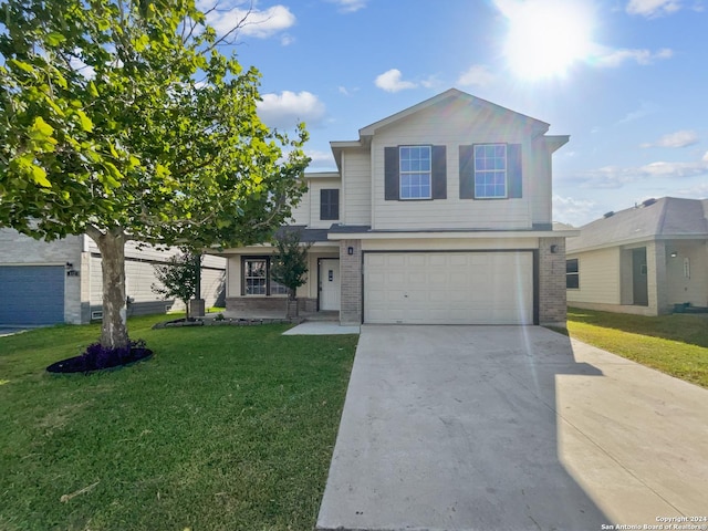 view of property with a garage and a front lawn