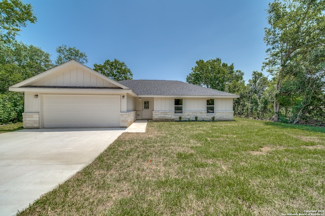 ranch-style home with a garage and a front yard